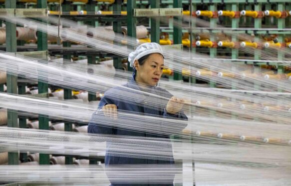 Worker at a chemical fibre plant, China.