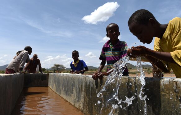 Children drink water from a pipeline in the village of Afraaga, Somaliland.